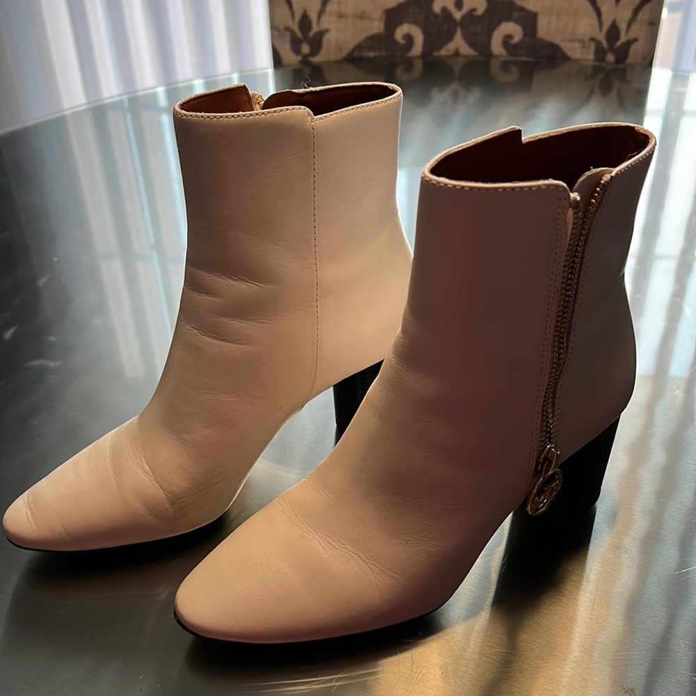 Women’s cream colored Coach boot.